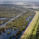 Addicks Reservoir, one of two basins—along with Barker Reservoir—that together protect downtown Houston. Together they hold 500 million cubic metres of water. The record-breaking rainfall pouring into Buffalo Bayou, which feeds the reservoirs, pushed the water level higher than it had ever reached. Homeowners upstream, discovered to their surprise that their land was in the basin. Their houses were flooded, in some cases requiring major repairs. Water officials eventually opened gates, letting water rush out of Addicks into downstream reaches of Buffalo Bayou, flooding homes there as well.